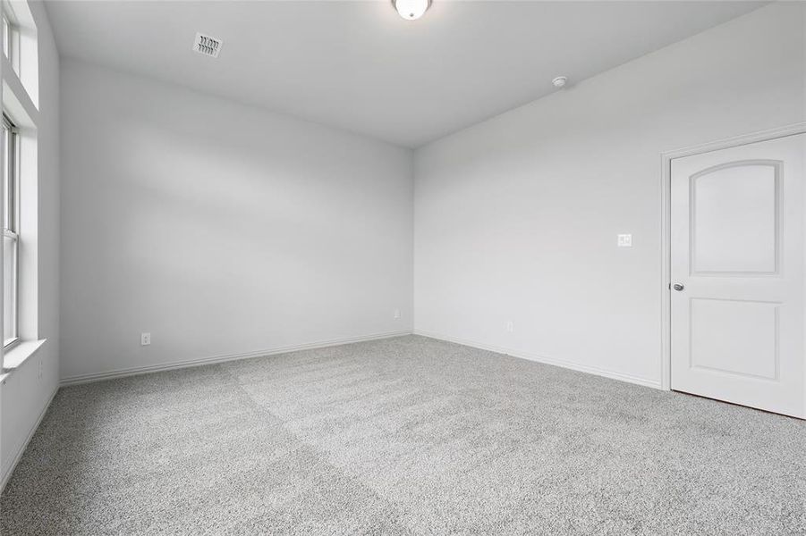 Spare room with carpet flooring and plenty of natural light Spare room with carpet flooring and plenty of natural light