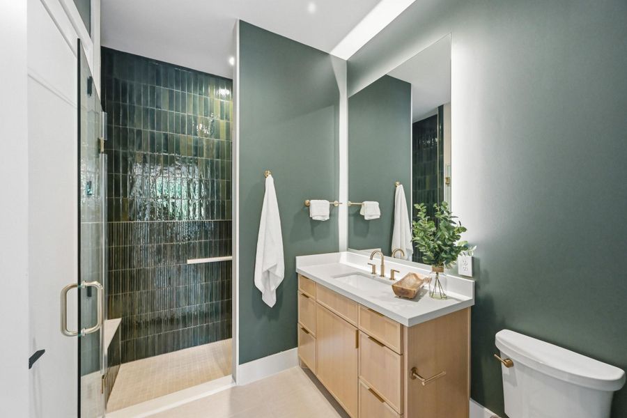 The ground floor full bath boasts a walk-in shower and gorgeous organic modern finishes!