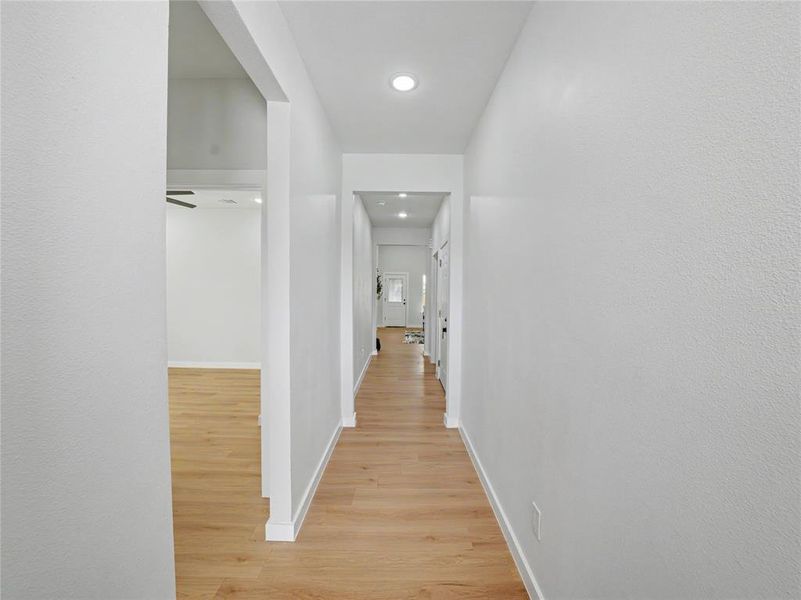 Corridor featuring light wood-type flooring and recessed lighting