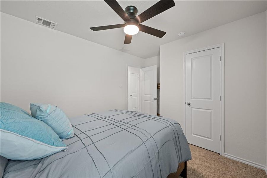 Bedroom featuring carpet flooring and ceiling fan Bedroom featuring carpet flooring and ceiling fan