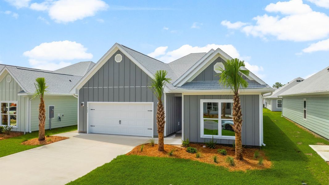 Front exterior of a new home in WindMark Beach, Port Saint Joe, FL, highlighting curb appeal (Image 22).