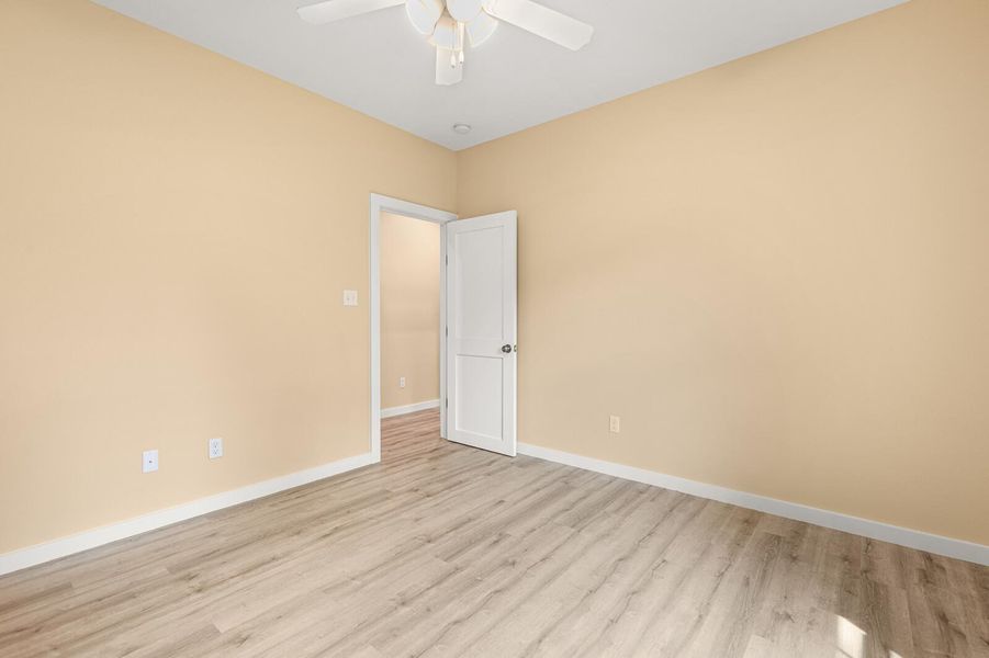 Spare room featuring light wood-type flooring and a ceiling fan