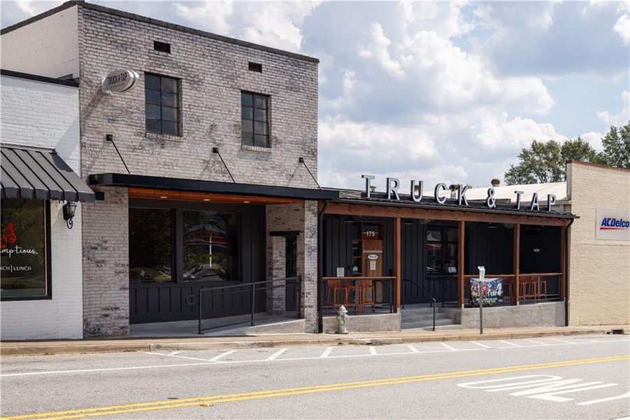 Front exterior of a new home in Rhodes Glen, Lawrenceville, GA, highlighting curb appeal (Image 1).