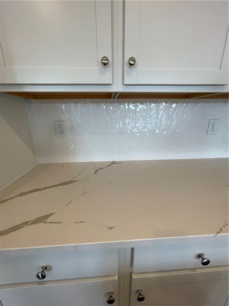 This modern kitchen features pristine cabinetry an