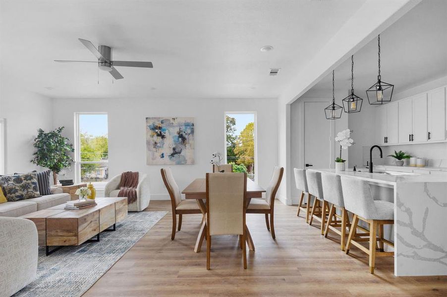 Dining area with ceiling fan, light wood-type flooring, and a wealth of natural light