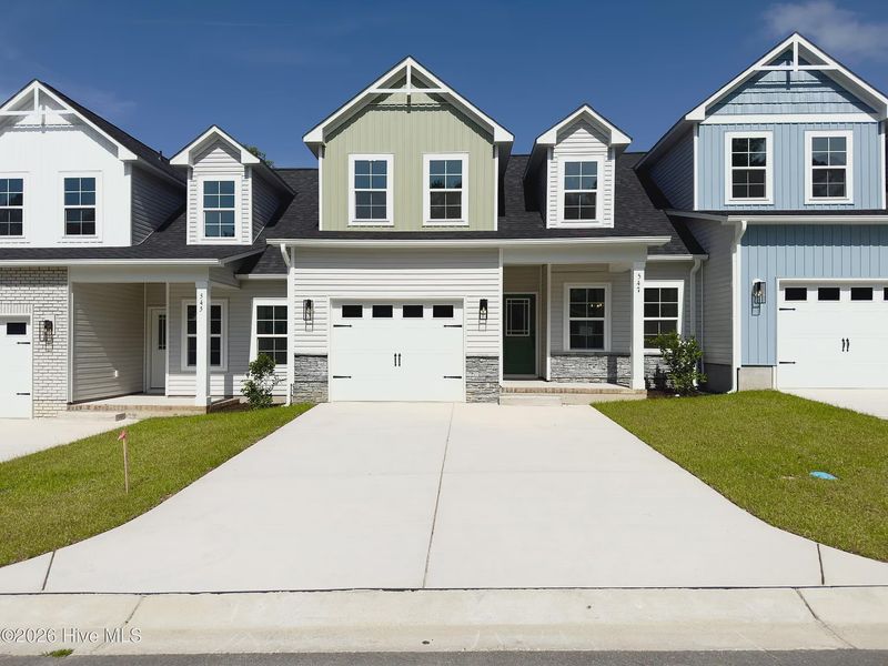 Front exterior of a new home in Autumn Trail, Bolivia, NC, highlighting curb appeal (Image 1). Front exterior of a new home in Autumn Trail, Bolivia, NC, highlighting curb appeal (Image 1).