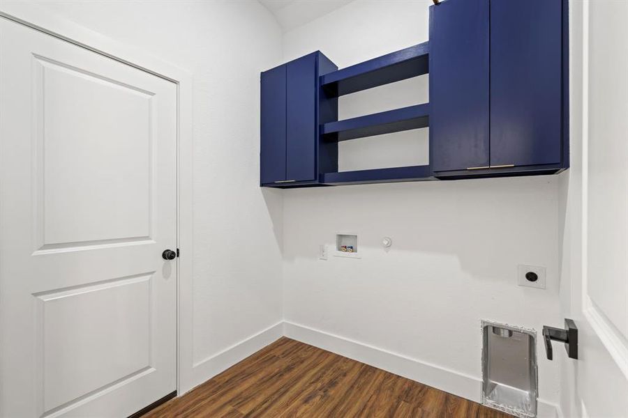 Laundry room featuring dark wood finished floors, hookup for a gas dryer, cabinet space, washer hookup, and hookup for an electric dryer