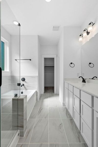 The soft glow of natural light filters through large windows, highlighting the elegant finishes – think polished countertops and luxurious tile work that catches your eye and invites you to linger.