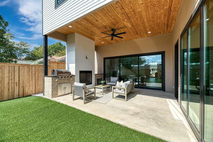 View of patio / terrace featuring an outdoor kitchen, ceiling fan, and outdoor lounge area View of patio / terrace featuring an outdoor kitchen, ceiling fan, and outdoor lounge area