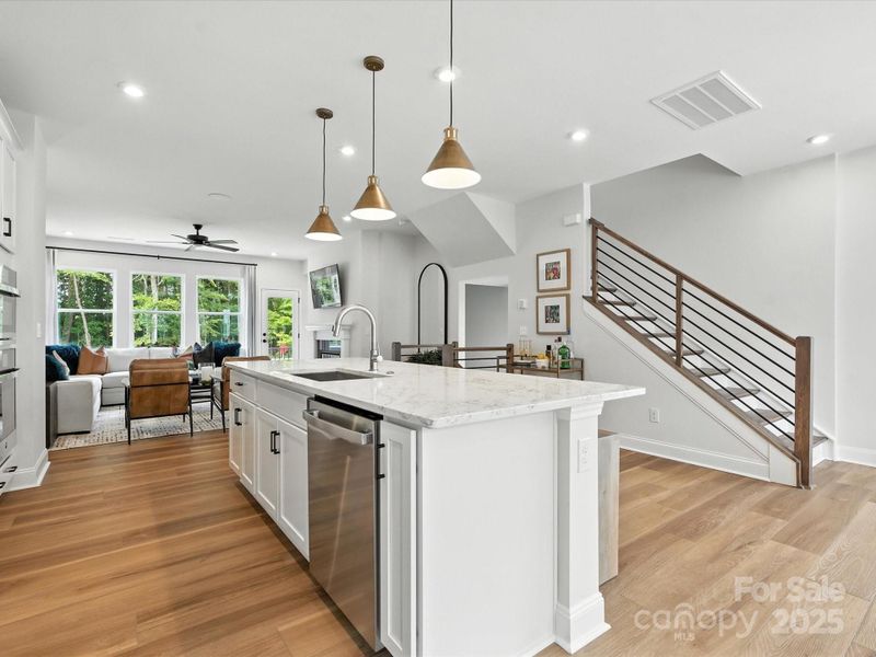 Large Central Island Ideal for Casual Dining and Entertaining. *Model Photos | Actual Finishes, Structural Selection, and Orientation May Vary.