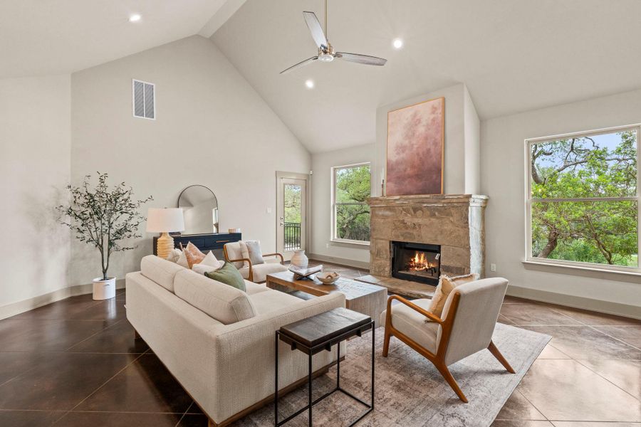 Spacious living area featuring a vaulted ceiling