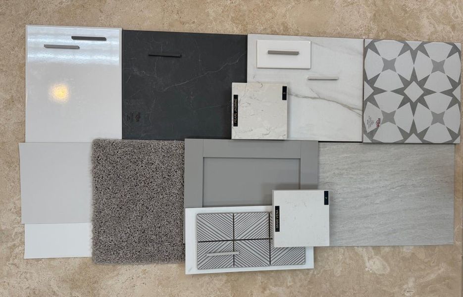 Interior design material board with cabinet samples, stone countertop swatches, tile patterns, and carpet in gray and white tones