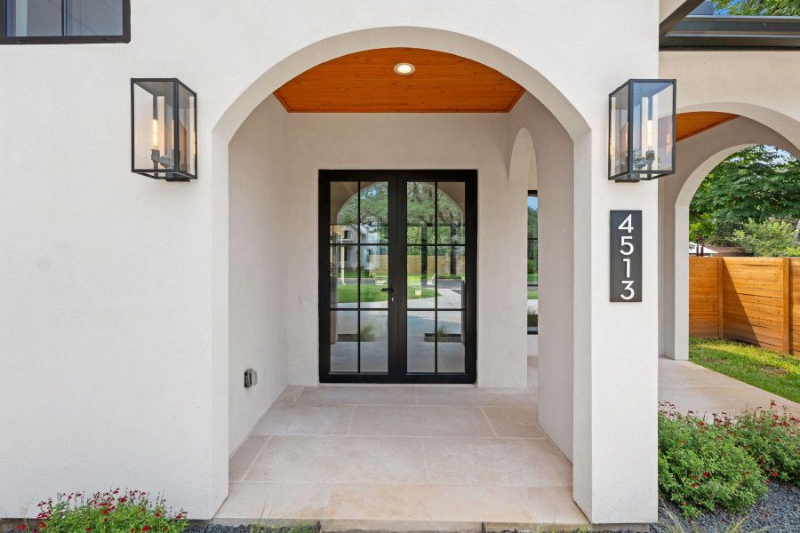Elegant arched entry with a natural wood ceiling, inviting you into this distinguished residence. Elegant arched entry with a natural wood ceiling, inviting you into this distinguished residence.