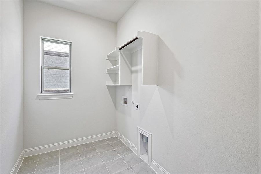 Laundry area featuring washer hookup, hookup for an electric dryer, light tile patterned floors, and gas dryer hookup