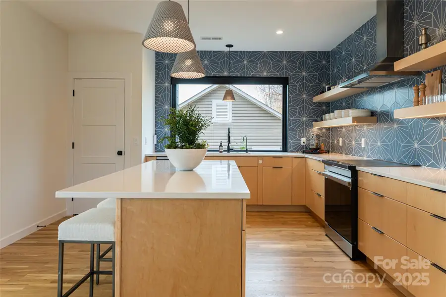 The kitchen features an island and dedicated pantry The kitchen features an island and dedicated pantry