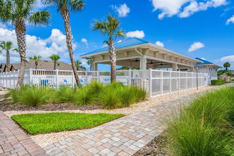 Front exterior of a new home in Celebration Pointe, Fort Pierce, FL, highlighting curb appeal (Image 21).