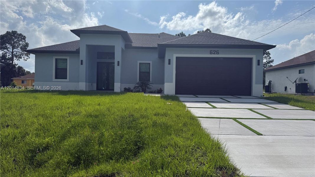 Front exterior of a new home in , Lehigh Acres, FL, highlighting curb appeal (Image 30).