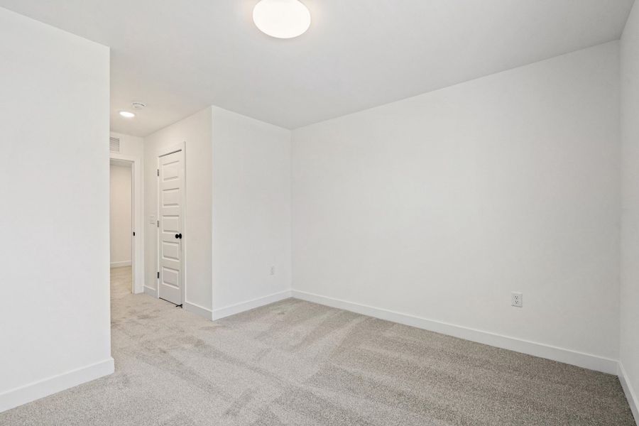Neutral gray carpet flooring complements white painted walls and trim