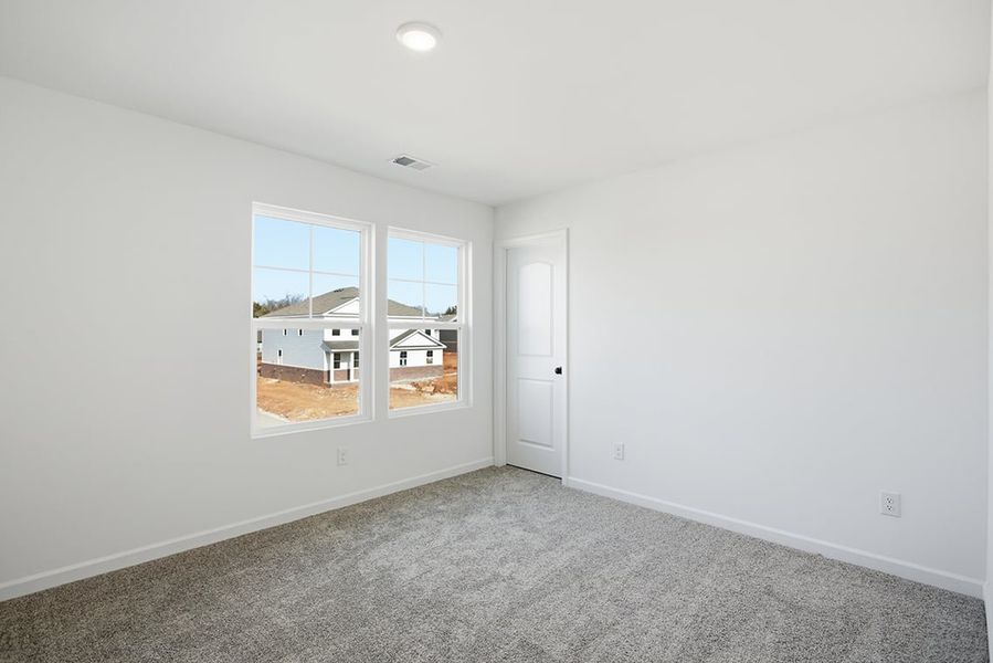 A room with a window and a door.