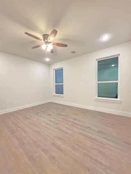 Picture of Master Bedroom with plenty of lightning, luxury vinyl flooring, and high white baseboards