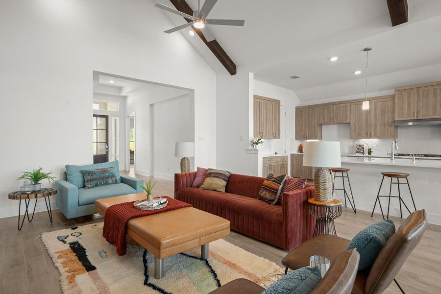 An open concept living area connects seamlessly with the kitchen, featuring high ceilings and elegant recessed lighting.