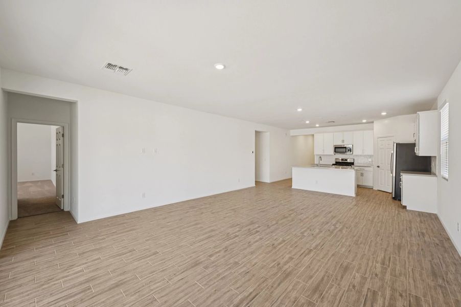 Great room, dining and kitchen. Not actual home, finishes may vary.