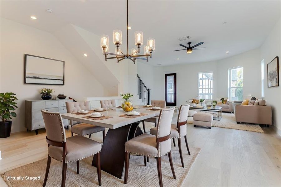 Dining space featuring light wood-style flooring, stairs, visible vents, and recessed lighting