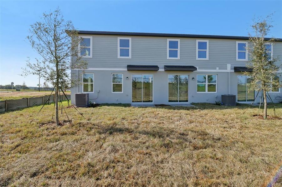 Exterior details and patio area of a home in The Reserve at Hammock Oaks Townes, Lady Lake (Image 19).
