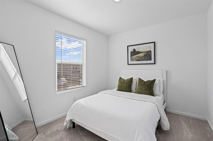 Bedroom with light carpet