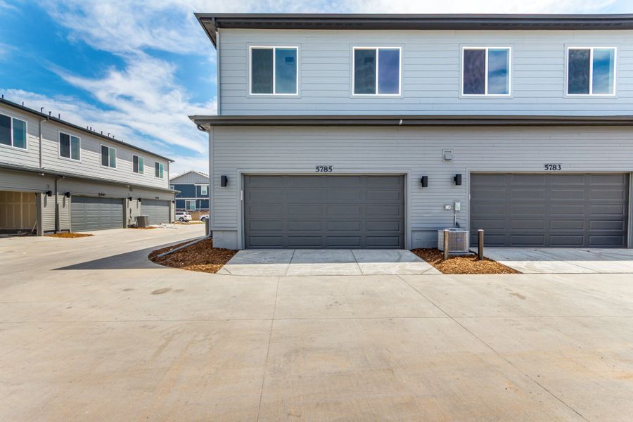 Front exterior of a new home in Painted Prairie, Aurora, CO, highlighting curb appeal (Image 17).