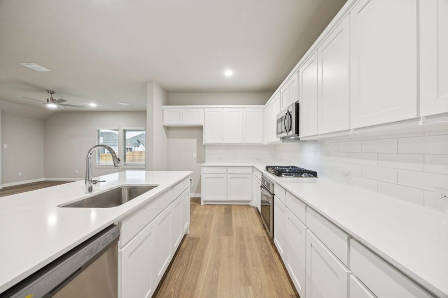 Kitchen in the Oscar home plan by Trophy Signature Homes – REPRESENTATIVE PHOTO Kitchen in the Oscar home plan by Trophy Signature Homes – REPRESENTATIVE PHOTO