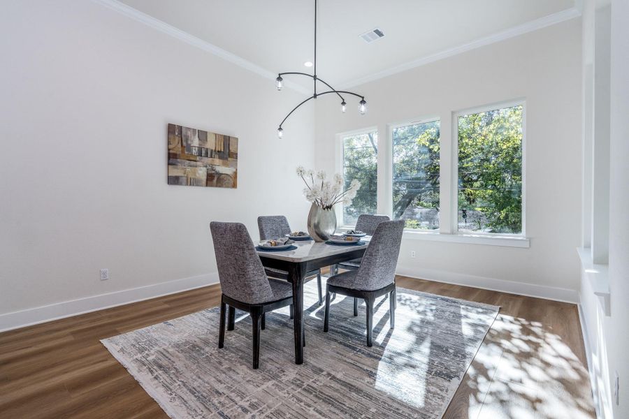 Luxurious open-concept dining area highlighted by oversized windows, elevated finishes, and a bright, airy atmosphere that enhances every meal. Luxurious open-concept dining area highlighted by oversized windows, elevated finishes, and a bright, airy atmosphere that enhances every meal.