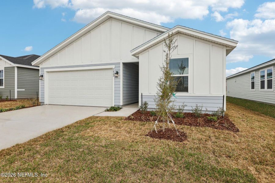 Front exterior of a new home in Cypress Meadows - Signature Series, Jacksonville, FL, highlighting curb appeal (Image 21).