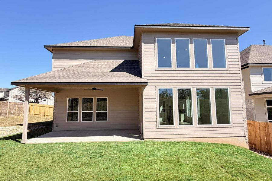 Rear view of house with a fenced backyard, a ceiling fan, a patio, and roof with shingles