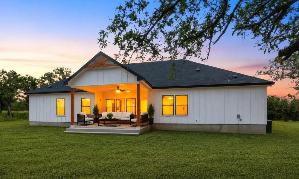 ** Virtual enhanced **  A spacious backyard patio, features a ceiling fan and recessed lighting.