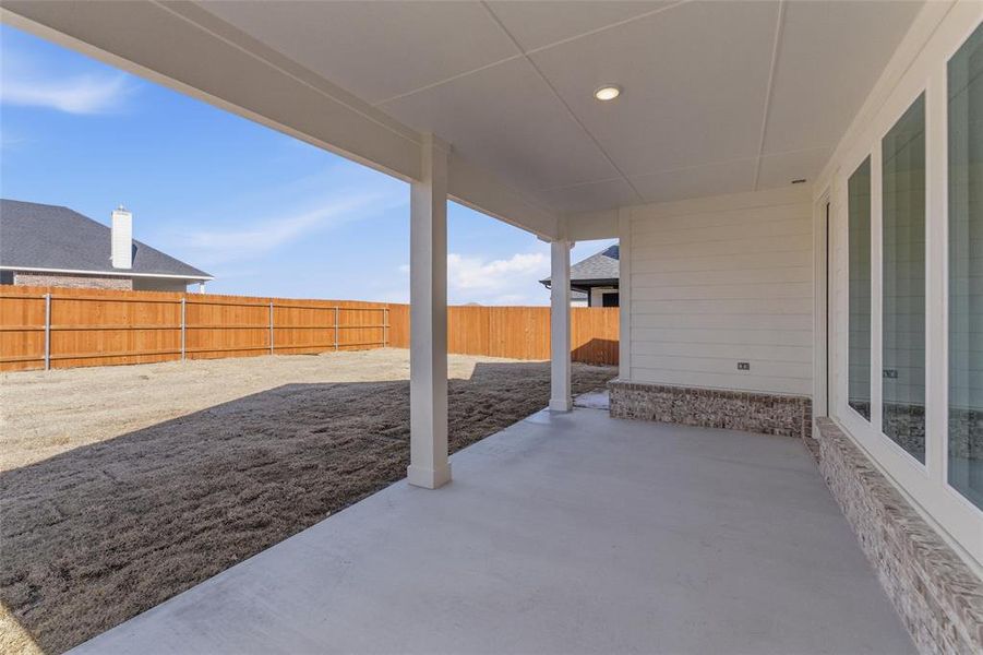 Fenced backyard featuring a patio