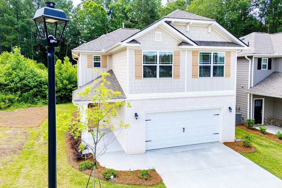 Front exterior of a new home in Windmill Park, Carrollton, GA, highlighting curb appeal (Image 2). Front exterior of a new home in Windmill Park, Carrollton, GA, highlighting curb appeal (Image 2).