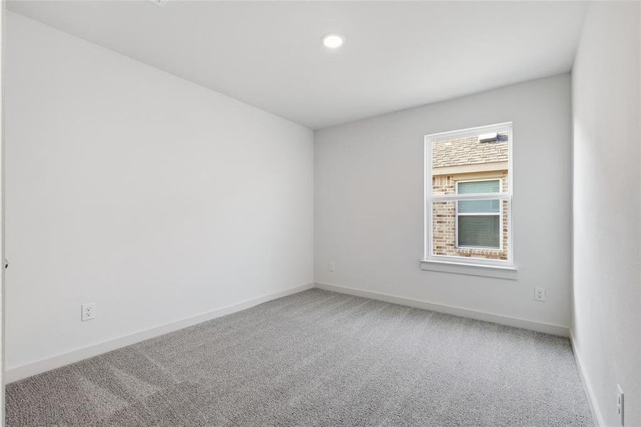 Carpeted spare room featuring baseboards and recessed lighting Carpeted spare room featuring baseboards and recessed lighting