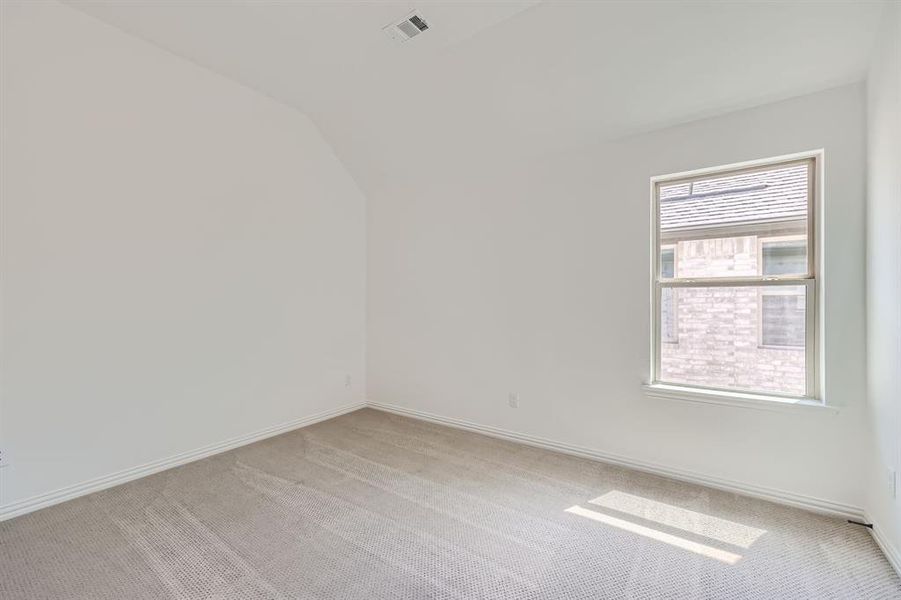 Secondary bedroom with vaulted ceiling