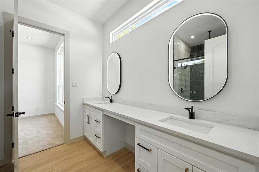 Full bath with double vanity, wood tiled floors, tiled shower, and recessed lighting Full bath with double vanity, wood tiled floors, tiled shower, and recessed lighting