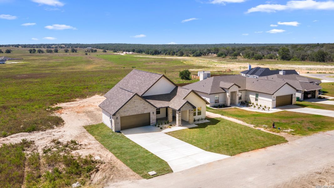 Front exterior of a new home in , La Vernia, TX, highlighting curb appeal (Image 17).