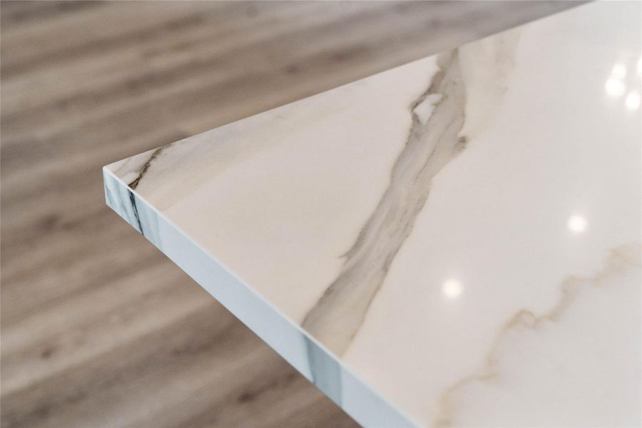 Kitchen countertops - quartz with subtle, elegant gray veining and a clean, modern edge profile.
