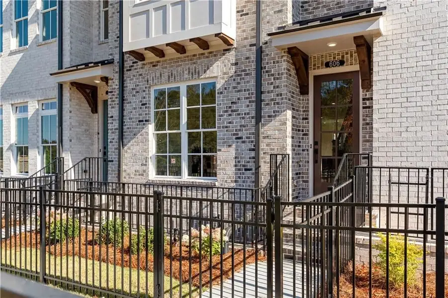 View of exterior entry with brick siding and a gate View of exterior entry with brick siding and a gate