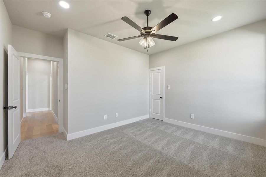 Unfurnished room with light colored carpet, recessed lighting, and a ceiling fan