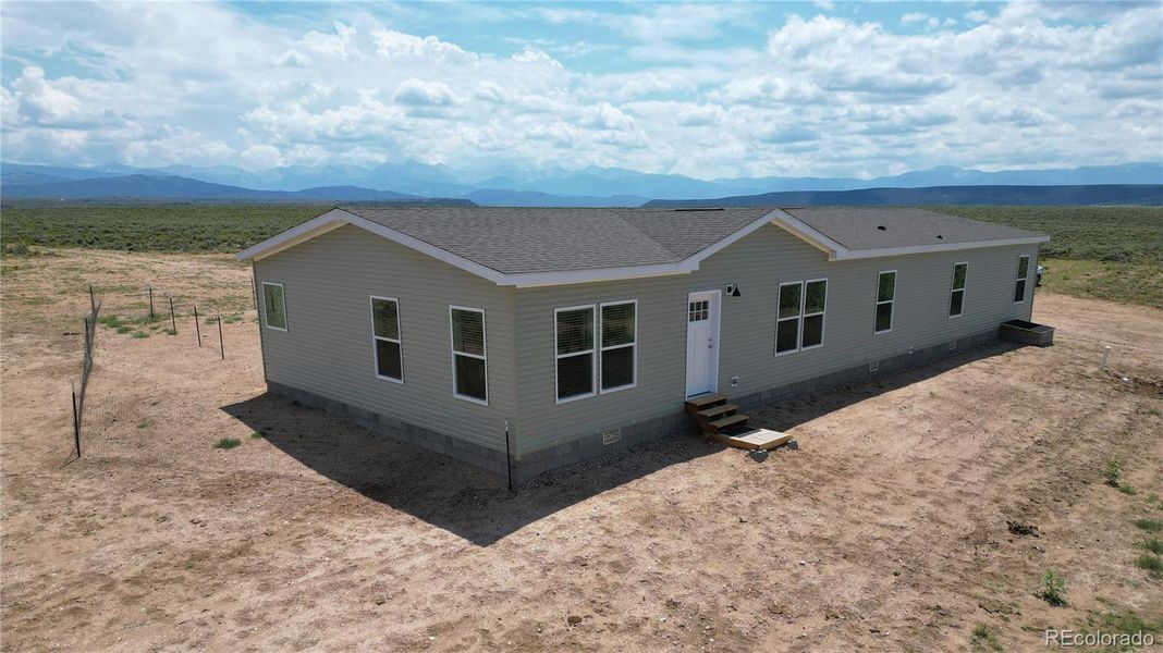 Front exterior of a new home in , San Luis, CO, highlighting curb appeal (Image 1). Front exterior of a new home in , San Luis, CO, highlighting curb appeal (Image 1).