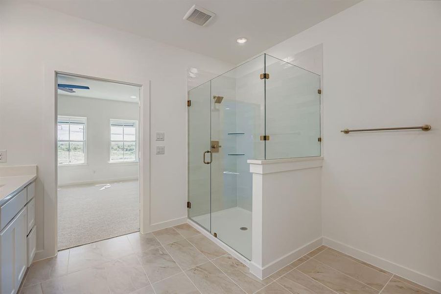 Bathroom featuring vanity, a shower stall, and recessed lighting Bathroom featuring vanity, a shower stall, and recessed lighting