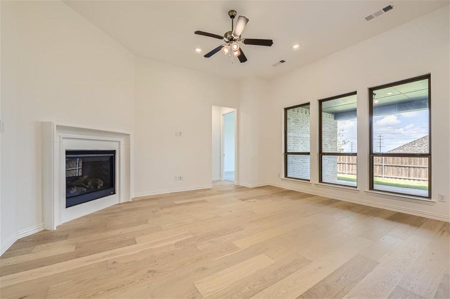 Unfurnished living room featuring light hardwood / wood-style floors and ceiling fan