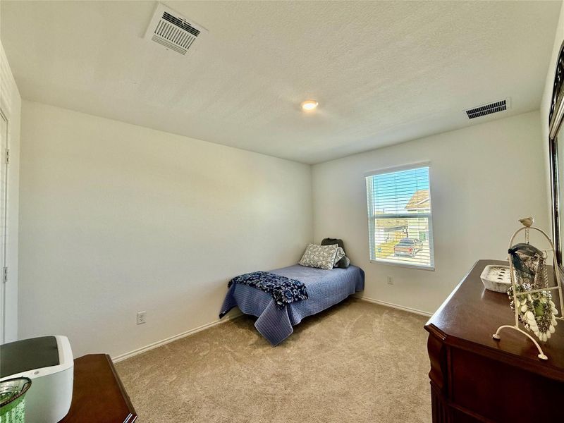 Bedroom with carpet floors and a textured ceiling
