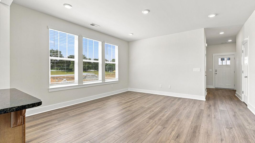 Eye-catching family room with elegant millwork and seamless access to dining and kitchen in Piedmont, SC Eye-catching family room with elegant millwork and seamless access to dining and kitchen in Piedmont, SC
