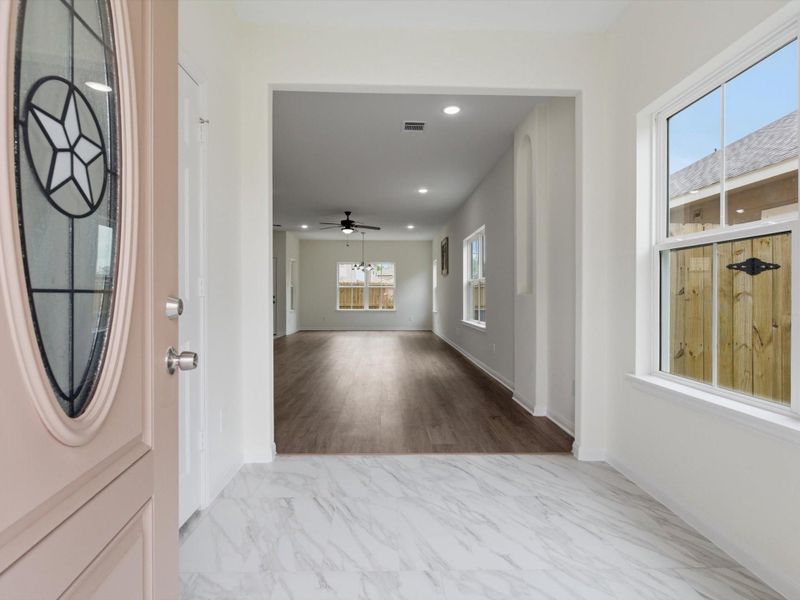 The entry sets the tone with elevated ceilings, sleek finishes, and a thoughtfully designed layout that flows effortlessly throughout the home.